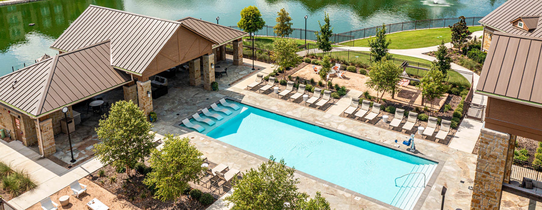 aerial shot of pool area and pond