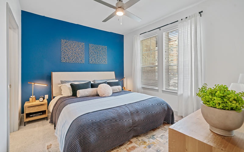 large bedroom with ceiling fan and light fixture