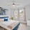 ceiling fan and light fixture in large bedroom