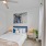 large windows brighten carpeted bedroom