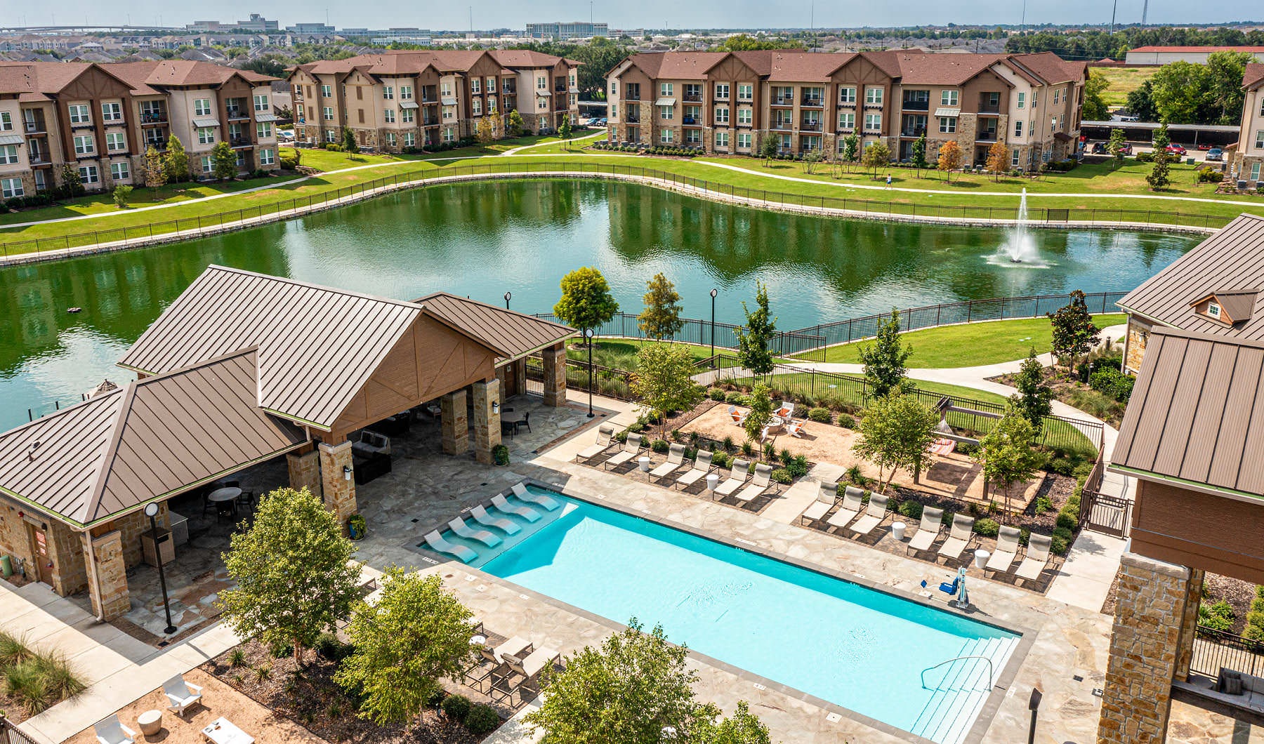 aerial shot of pool area and pond